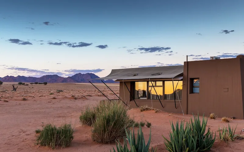 Pool deck looking out over the desert at Sossusvlei Lodge at the Sesriem gate, Namib Desert, Namibia